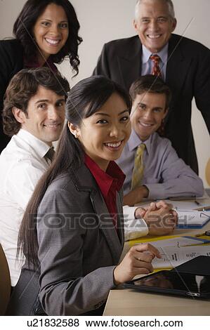 People at business meeting looking at camera View Large Photo Image Stock Photo - People at business meeting looking at camera. Fotosearch