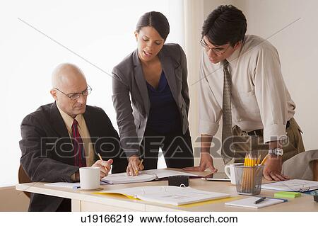 Stock Photo - People discussing at business meeting. Fotosearch