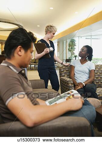 Stock Image - People in hospital's hall talking. Fotosearch