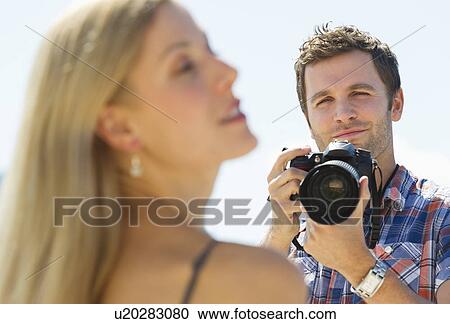 Photographer taking picture of woman View Large Photo Image Stock Image - Photographer taking picture of woman. Fotosearch