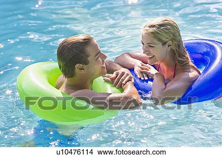Picture - Portrait couple in swimming pool. Fotosearch
