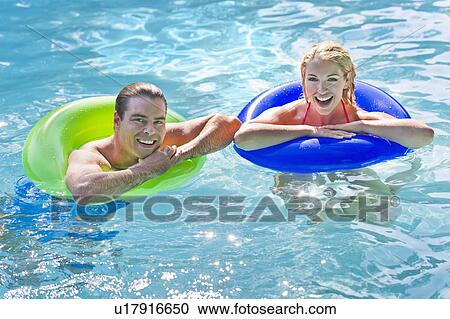 Portrait couple in swimming pool View Large Photo Image Stock Image - Portrait couple in swimming pool. Fotosearch