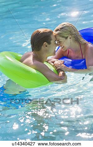 Portrait couple in swimming pool View Large Photo Image Stock Photo - Portrait couple in swimming pool. Fotosearch