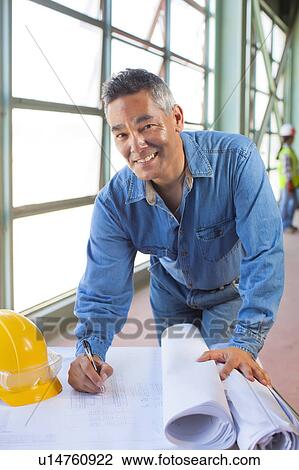 Portrait of architect drawing blueprint View Large Photo Image Stock Image - Portrait of architect drawing blueprint. Fotosearch
