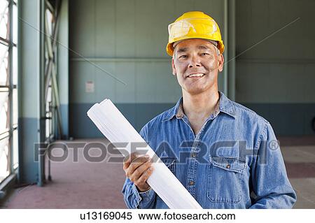 Portrait of architect holding blueprint View Large Photo Image Stock Photography - Portrait of architect holding blueprint. Fotosearch
