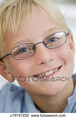 Portrait of blonde boy (10-11) wearing glasses View Large Photo Image Stock Image - Portrait of blonde boy (10-11) wearing glasses. Fotosearch