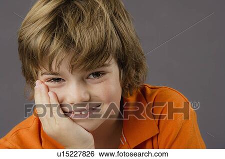 Stock Photograph - Portrait of boy (8-9), studio shot. Fotosearch
