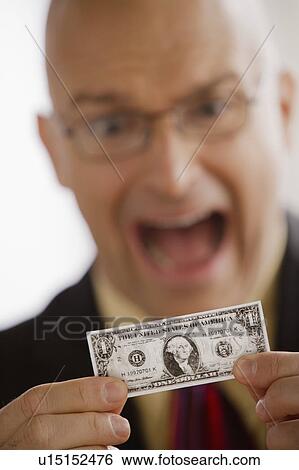 Portrait of business man holding one dollar bill View Large Photo Image Stock Photograph - Portrait of business man holding one dollar bill. Fotosearch