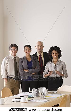 Stock Image - Portrait of business team in board room. Fotosearch