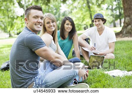 Portrait of college students relaxing on grass View Large Photo Image Stock Image - Portrait of college students relaxing on grass. Fotosearch