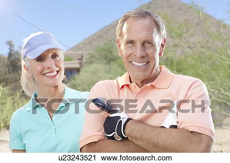 Portrait of couple on golf course View Large Photo Image Stock Image - Portrait of couple on golf course. Fotosearch