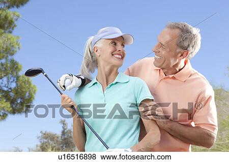 Portrait of couple on golf course View Large Photo Image Stock Photo - Portrait of couple on golf course. Fotosearch