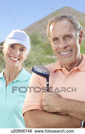 Stock Photo - Portrait of couple on golf course. Fotosearch