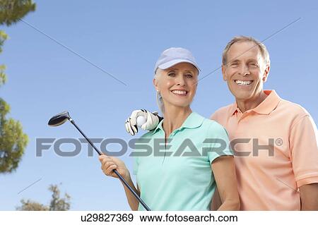 Stock Photo - Portrait of couple on golf course. Fotosearch