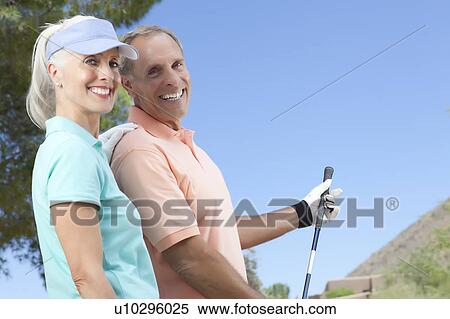 Stock Photography - Portrait of couple on golf course. Fotosearch