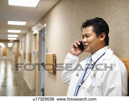 Stock Photo - Portrait of doctor talking on mobile phone. Fotosearch