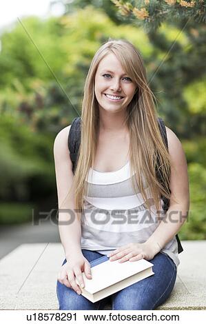 Stock Image - Portrait of female college student smiling. Fotosearch