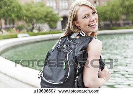 Portrait of female college student showing backpack View Large Photo Image Stock Photo - Portrait of female college student showing backpack. Fotosearch