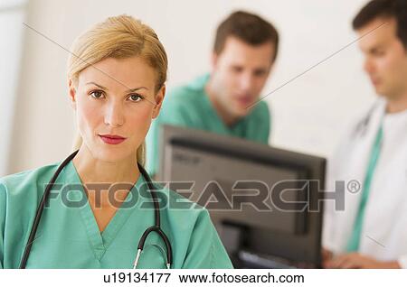 Portrait of female doctor in front of nurse's station View Large Photo Image Stock Photo - Portrait of female doctor in front of nurse's station. Fotosearch