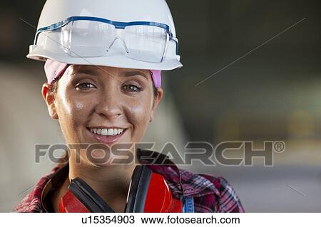 Portrait of female manual worker wearing hardhat View Large Photo Image Stock Image - Portrait of female manual worker wearing hardhat. Fotosearch