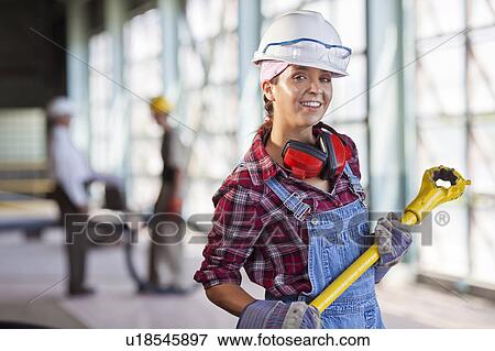 Portrait of female manual worker wearing hardhat View Large Photo Image Stock Photo - Portrait of female manual worker wearing hardhat. Fotosearch
