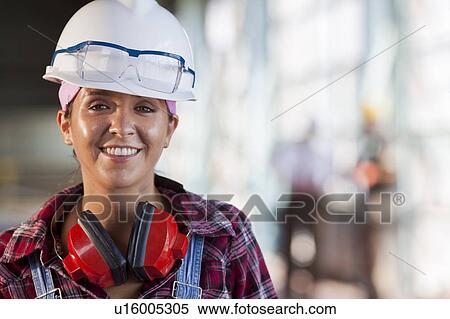 Portrait of female manual worker wearing hardhat View Large Photo Image Stock Photography - Portrait of female manual worker wearing hardhat. Fotosearch