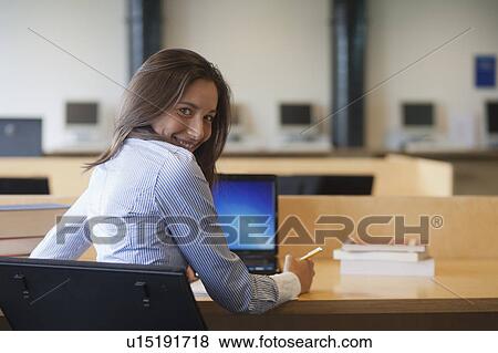 Portrait of female student studying in library View Large Photo Image Stock Photo - Portrait of female student studying in library. Fotosearch