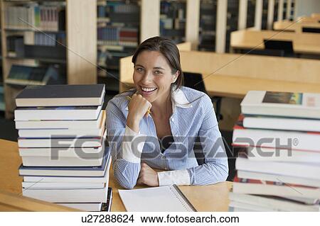 Portrait of female student with books in library View Large Photo Image Picture - Portrait of female student with books in library. Fotosearch