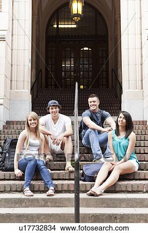 Portrait of four college students sitting on steps View Large Photo Image Picture - Portrait of four college students sitting on steps. Fotosearch