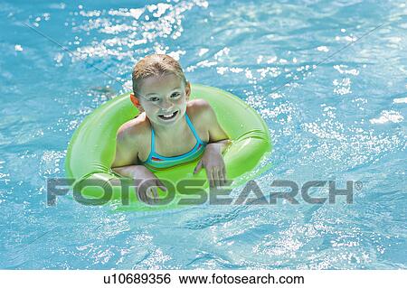 Portrait of girl (10-11) in swimming pool View Large Photo Image Stock Photograph - Portrait of girl (10-11) in swimming pool. Fotosearch