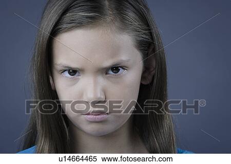 Portrait of girl (8-9) looking angry, studio shot View Large Photo Image Stock Photography - Portrait of girl (8-9) looking angry, studio shot. Fotosearch