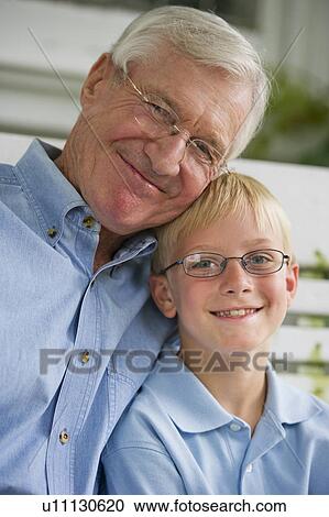 Stock Image - Portrait of grandfather and grandson (10-11). Fotosearch
