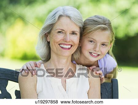 Stock Photo - Portrait of grandmother with granddaughter (10-11) . Fotosearch