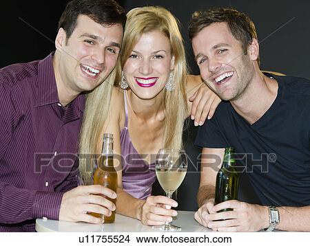 Picture - Portrait of group of friends drinking in nightclub. Fotosearch