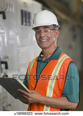 Stock Image - Portrait of industrial worker in hard hat. Fotosearch