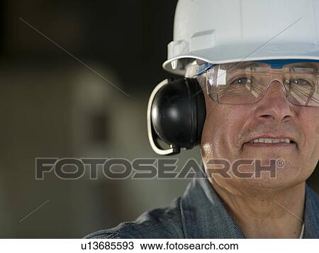 Portrait of industrial worker wearing hard hat and ear protectors View Large Photo Image Stock Image - Portrait of industrial worker wearing hard hat and ear protectors. Fotosearch