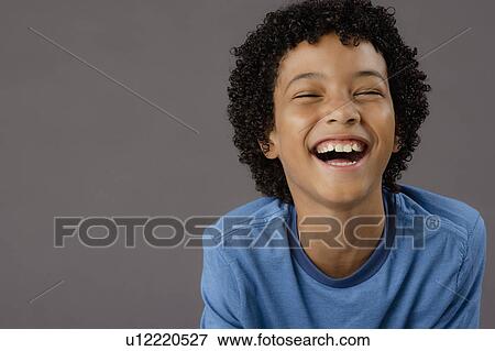 Portrait of laughing boy (8-9), studio shot View Large Photo Image Stock Photo - Portrait of laughing boy (8-9), studio shot. Fotosearch
