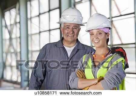 Stock Image - Portrait of male and female manual workers. Fotosearch