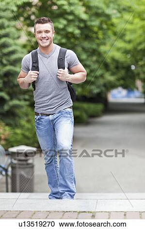 Stock Image - Portrait of male college student smiling. Fotosearch
