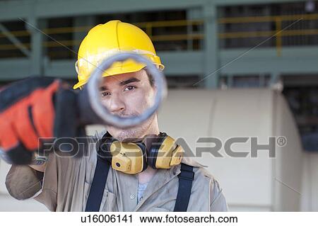 Portrait of male manual worker holding tool View Large Photo Image Stock Image - Portrait of male manual worker holding tool. Fotosearch