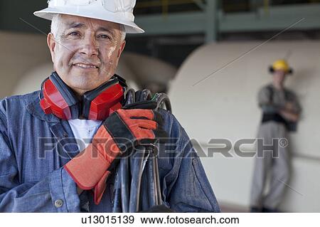 Portrait of male manual worker wearing hardhat View Large Photo Image Stock Photo - Portrait of male manual worker wearing hardhat. Fotosearch