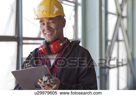 Portrait of male manual worker wearing hardhat View Large Photo Image Stock Photography - Portrait of male manual worker wearing hardhat. Fotosearch