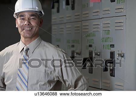 Portrait of male technician wearing hardhat View Large Photo Image Stock Photo - Portrait of male technician wearing hardhat. Fotosearch