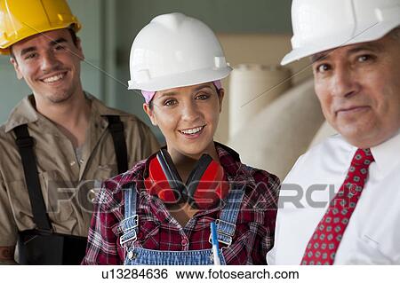 Stock Photograph - Portrait of manual workers and manager. Fotosearch