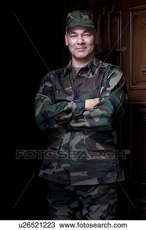 Stock Image - Portrait of mature man wearing military uniform. Fotosearch
