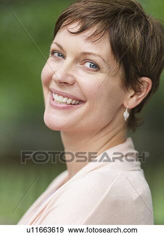 Portrait of mature woman smiling View Large Photo Image Stock Photo - Portrait of mature woman smiling. Fotosearch