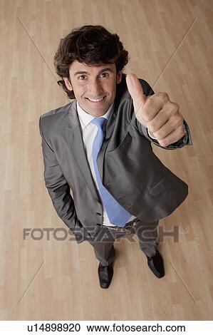 Portrait of mid adult businessman with thumb up View Large Photo Image Stock Image - Portrait of mid adult businessman with thumb up. Fotosearch
