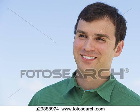 Picture - Portrait of mid adult man against blue sky. Fotosearch