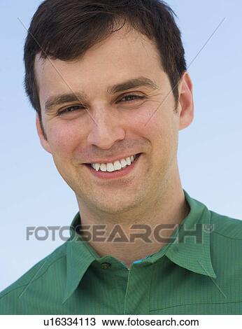 Portrait of mid adult man against blue sky View Large Photo Image Stock Image - Portrait of mid adult man against blue sky. Fotosearch