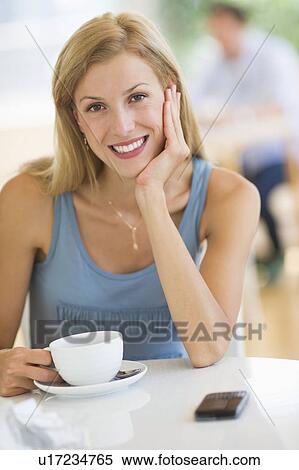 Stock Photography - Portrait of mid adult woman drinking coffee. Fotosearch